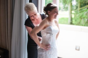 Helen Davies wedding planner helps bride with her dress before Beverley Wedding Yorkshire.